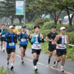 제주국제관광마라톤축제 당일 비 오는 날씨에 러너들이 기능성 러닝복을 입고 달리는 모습